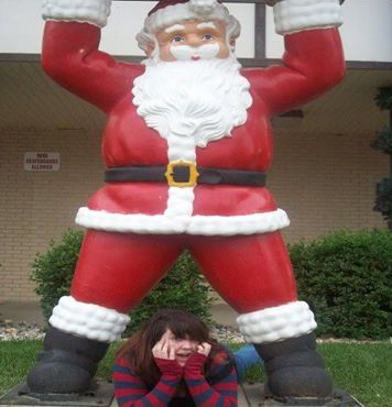 Me with Santa statue by post office when I was 17(there are about 25 santa statues all over town)
